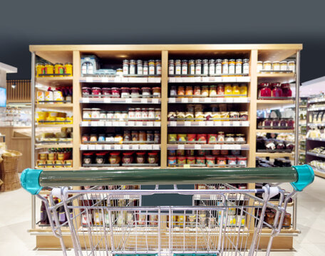 Abstract blurred supermarket.  choosing a dairy products at supermarket.empty grocery cart in an empty supermarket