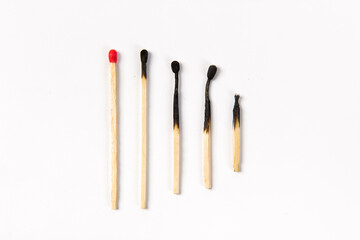 Different stages of match burning, Burnt matches on white background.