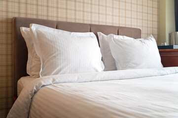 Comfortable room with clean bed linen, pillows, hotel interior
