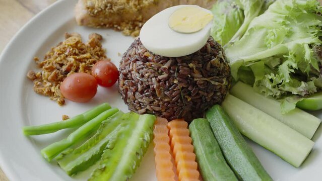 Fried salmon fish with riceberry (Riceberry is a rice variety from Thailand) and vegetable, healthy food style.