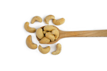 Cashew nuts in wooden spoon isolated on white background. Top view. Close-up. Selective focus.