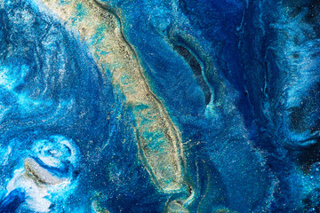 Luxury abstract background, liquid art. Blue alcohol ink with golden paint streaks, water surface, marble texture