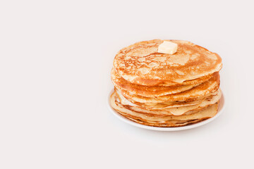 Staple of yeast fluffy pancakes with butter. Spring holiday Traditional Russian Shrovetide Maslenitsa week or pancake tuesday holiday. american crepes isolated on white gray background. side view