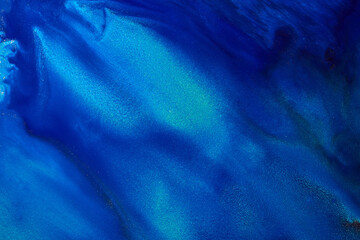 Luxury abstract background, liquid art. Blue alcohol ink with golden paint streaks, water surface, marble texture