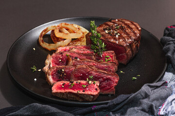 Rare cooking level Sirloin steak with spices and herbs. Classic grilled meat cut ready to eat
