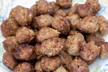 Baked homemade round dumplings isolated on wooden background.