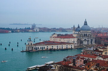 Picturesque aerial landscape view of Venice from the bell tower of the Cathedral of St. Mark. Famous touristic place and travel destination in Europe. Winter drizzle day in Venice