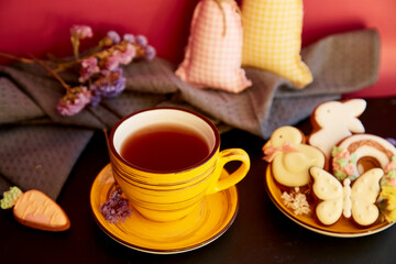 Aesthetic tea cup with Easter cookies and decorations. Holiday food, tea time