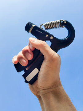 Adjustable hand gripper in the blue sky