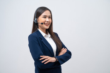 Beautiful Asian call center operator wearing a headset and microphone standing with her arms...