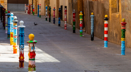 Pilon´s Street, curious street in the old town of Tarragona with the bollards painted in colors, Spain