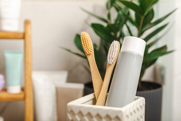 Eco bamboo toothbrushes and toothpaste tube mockup in the bathroom. Toothbrushes on the background...