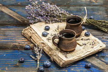 The concept of rustic style tea. Lavender flowers and blueberries. Vintage book