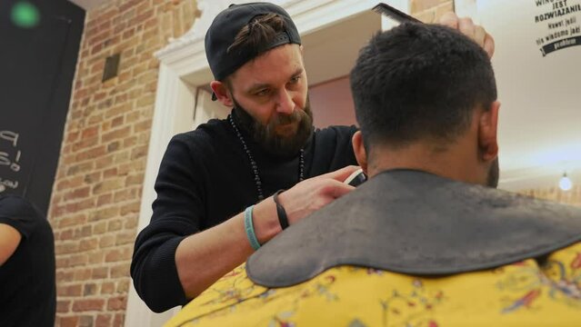 Low angle shot of back of a man's head. Haidresser during work. High quality 4k footage