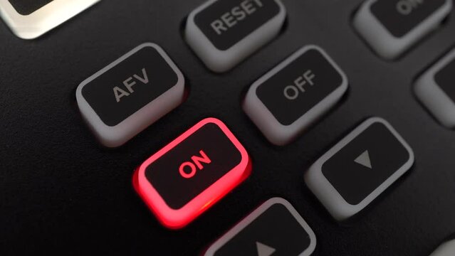 The man pressed the power button. Button to on the camera sound on the camera control panel. Macro.