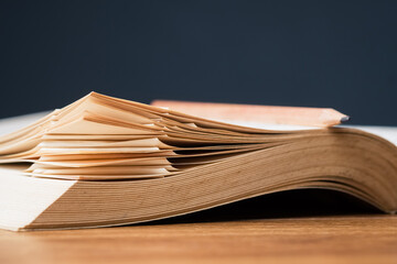 Closeup corner of the pages with many folded bookmarks in the old book