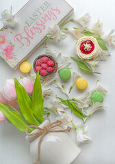 Easter background. Sweets colored macarons and flower petals. Delicate spring Easter background..