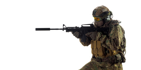 Cropped photo of a mercenary soldier with an automatic rifle in his hand aiming in enemy.