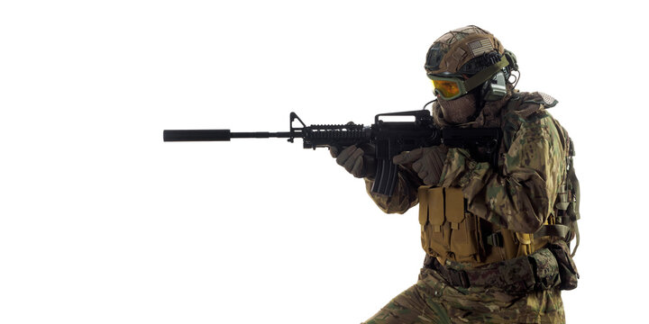 Cropped photo of a mercenary soldier with an automatic rifle in his hand aiming in enemy.