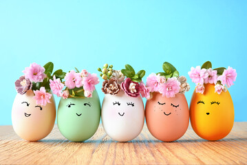 Funny Easter Eggs, hand drawn faces. Easter holiday concept with cute handmade eggs in floral wreath crowns. - 573922628