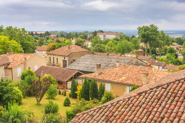 Summer city landscape - view of the roofs of houses in a provincial French town, in the historical province Gascony, the region of Occitanie of southwestern France