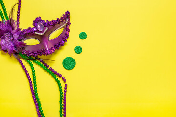 Mardi gras lettering. Congratulation card with violet mask on yellow background Top view 2023 Mardi...