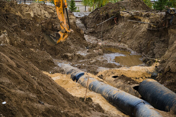 The excavator digs a deep ditch
