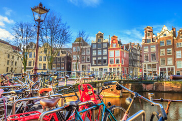 Cityscape on a sunny winter day - view of the bridge and canal in the historic center of Amsterdam, The Netherlands