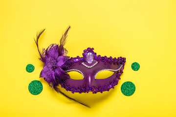 Mardi gras lettering. Congratulation card with violet mask on yellow background Top view 2023 Mardi...