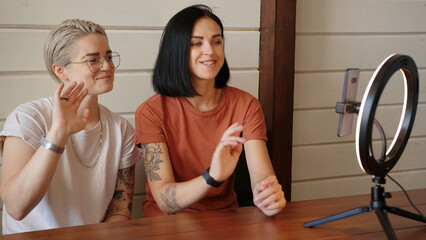 Lesbian girlfriends making online vlog live streaming tutorial using led ring light