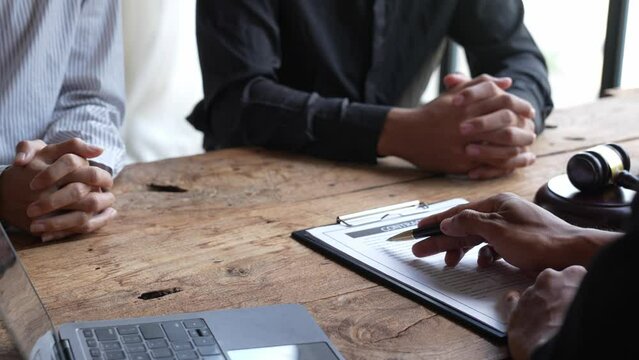 Attorneys or lawyers who are reading the statute of limitations Consultation between male lawyers and business clients, tax and legal and legal services firms.