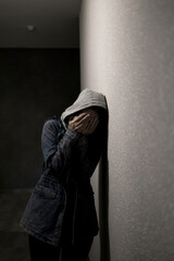 Silhouette of a depressed woman on the walkway of an apartment building. Sad woman, crying, drama,...