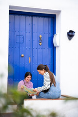 girls locating themselves with map in town