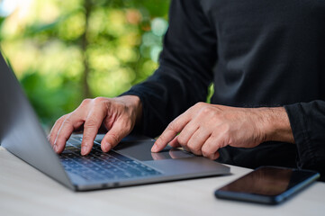 Businessman or programmer coding with laptop computer outdoor in garden. Programmer coding developer app for business company and require customer. student practice coding with laptop on summer