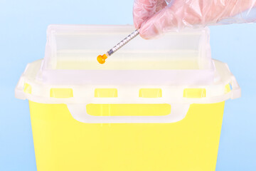 Disposing a medical syringe in sharps container