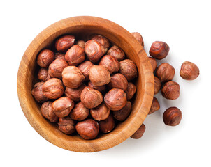 Hazelnut nut in a wooden plate on a white background. Top view