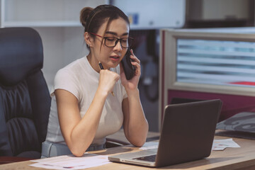 Fototapeta premium beautiful business asian woman using phone. female employee having a conference talking online with smartphone call. a serious professional office woman having internet cellphone meeting conversation