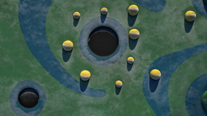 blue rubber surface of a playground with yellow scoops and colored spots in the frost of human...