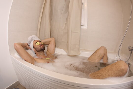Man doing his beauty routine in the bathtub 