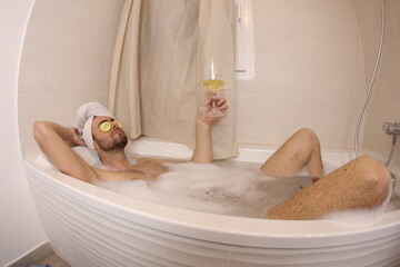 Man doing his beauty routine in the bathtub 