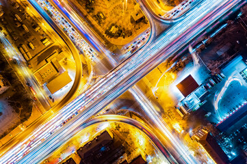 Aerial shot of car track with night view of city overpass