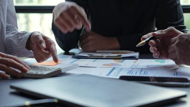 Financial analyst analysis business financial report on digital tablet during discussion at meeting of corporate showing the results of their successful teamwork., business meeting concept, Marketing	