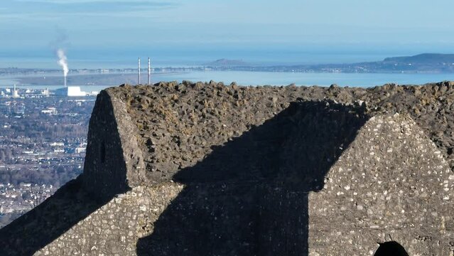 drone rising shot over hellfire club in dublin mountains, revealing dublin cityscape and dublin bay
