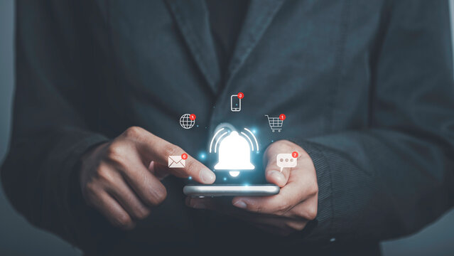 Man using smartphone with bell ringing application notification alert concept. New message, reminder, alarm ,Mail inbox, contact, New product marketing alert.