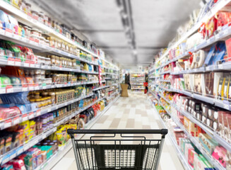 Abstract blurred supermarket.  choosing a dairy products at supermarket.empty grocery cart in an empty supermarket