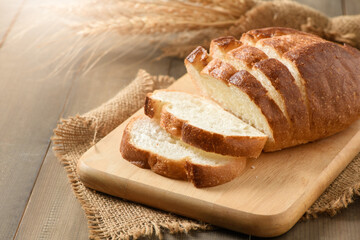 Sliced of fresh homemade french breads on wood background,