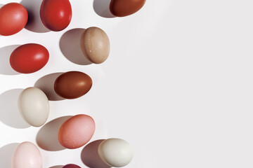 Frame from Easter eggs red gradient color with hard Shadow at sunlight, light background. Chicken eggs minimal flat lay, traditional food and symbol of Easter, monochrome color, top view