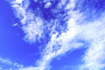 the sky looks bright blue with white clouds with abstract patterns
