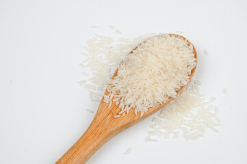 Rice food. Basmati rice in the wooden spoon, isolated on the white background