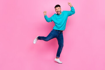 Fototapeta na wymiar Full body photo of young attractive male raise fists celebrate luck excited wear trendy blue clothes isolated on pink color background